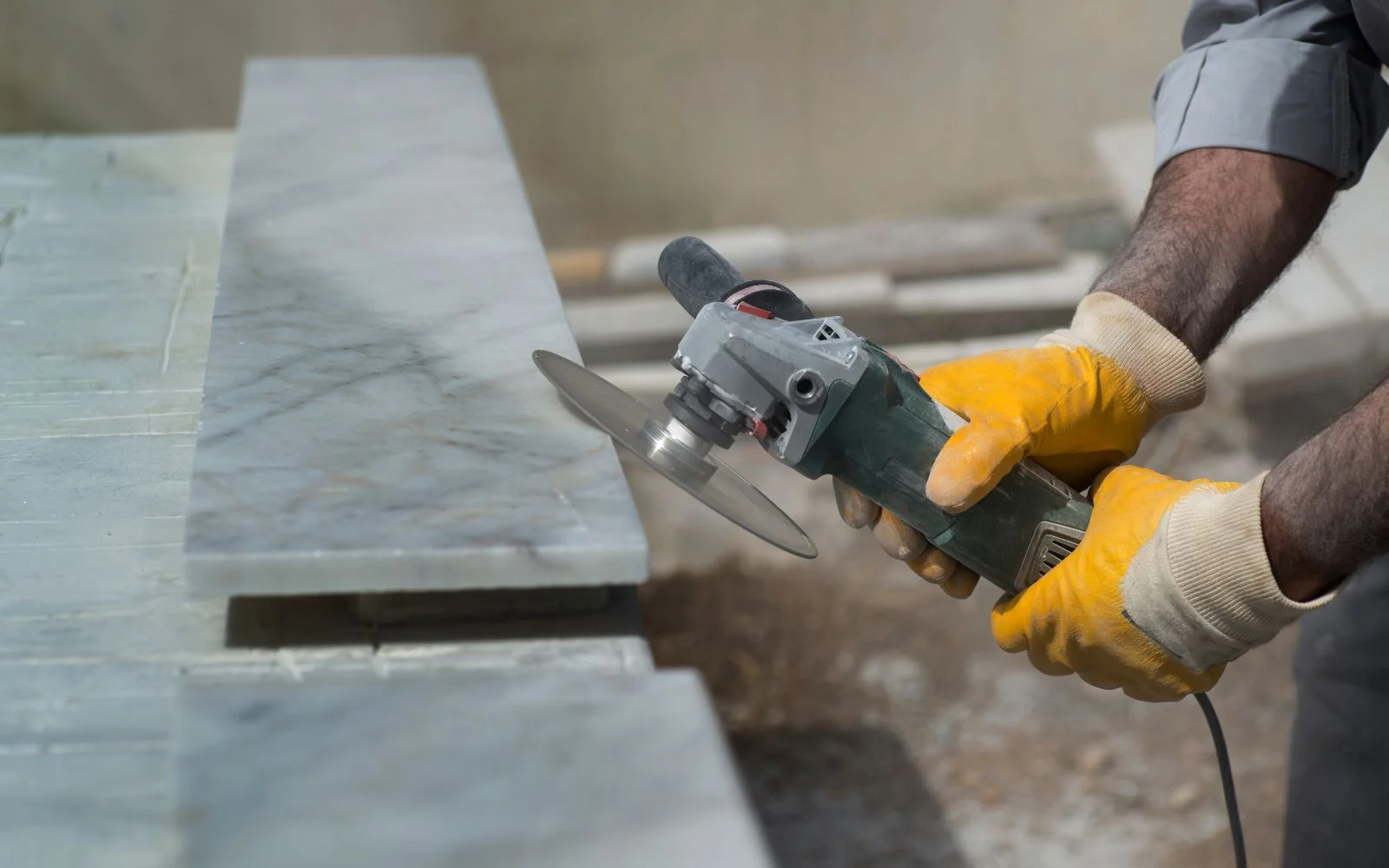 Stonemason repairing a stone surface in our Halifax workshop